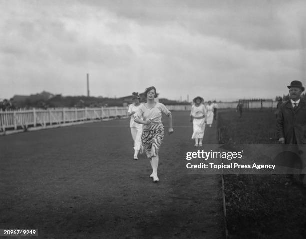 Female athlete named as A. McNaught competing in the single women's walking race at the Interkit AA meeting at Manor Park, July 1920. Most women...