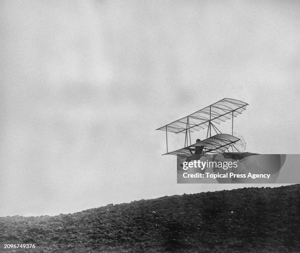 Francis Chardon, a bank clerk from Bern, Switzerland, flying a hang-glider biplane at a glider plane event in France, August 1922.