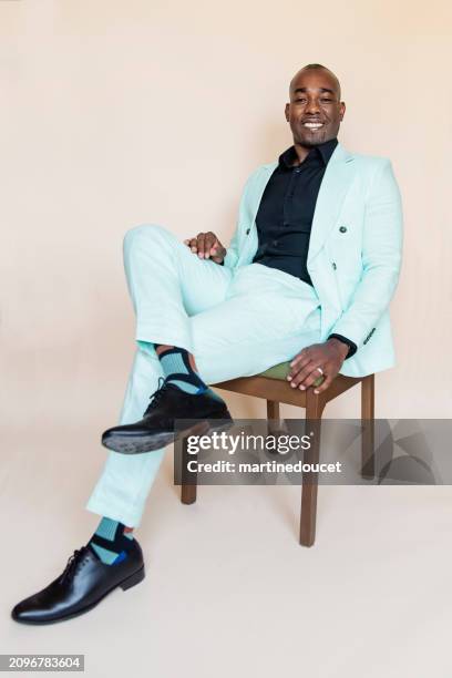 portrait of stylish modern professional black man on beige background. - suave stock pictures, royalty-free photos & images