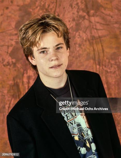 American actor Stephen Dorff, wearing a black jacket over a t-shirt during a studio portrait session, United States, circa 1987. Dorff's t-shirt...
