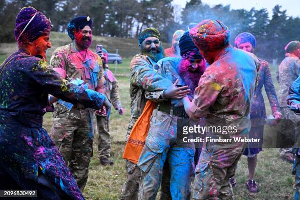 Soldiers celebrate with Rang, the throwing of coloured powder, on March 19, 2024 in Aldershot, England. Holla Mahalla, the annual Sikh military...