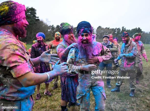 Soldiers celebrate with Rang, the throwing of coloured powder, on March 19, 2024 in Aldershot, England. Holla Mahalla, the annual Sikh military...