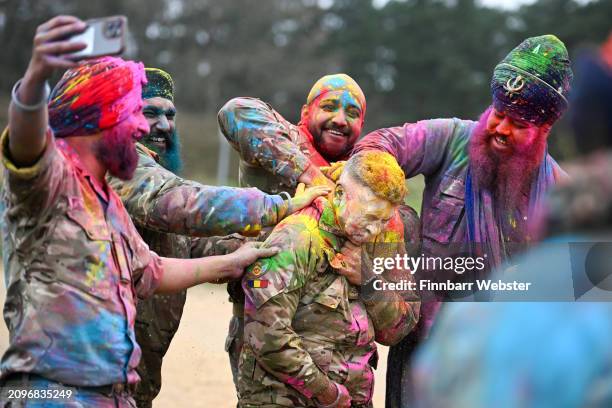 Soldiers celebrate with Rang, the throwing of coloured powder, on March 19, 2024 in Aldershot, England. Holla Mahalla, the annual Sikh military...