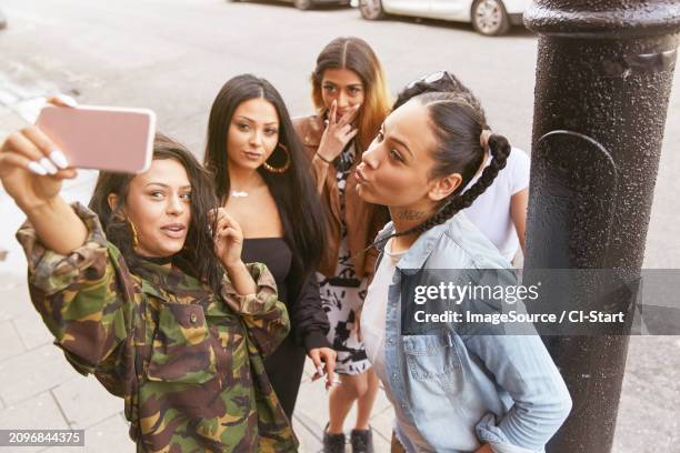 young woman taking selfie with friends - camouflage fabric stock pictures, royalty-free photos & images