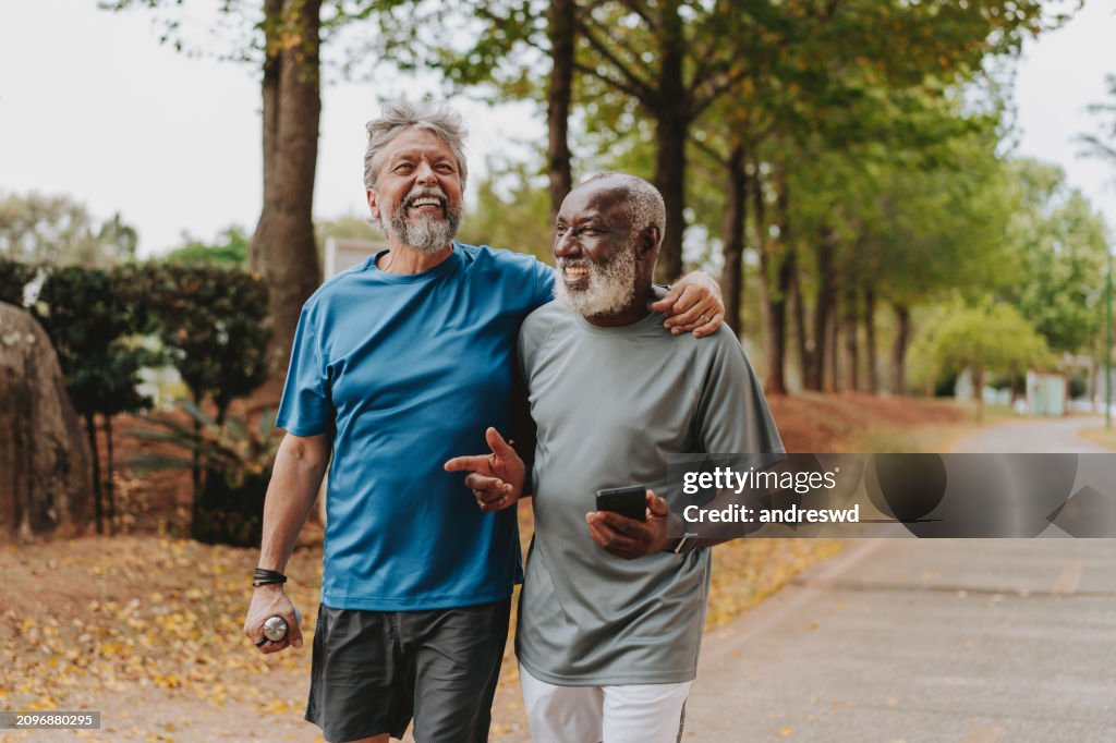Two senior friends running in the public park