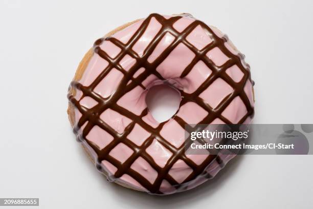 doughnut with pink icing - doughnut stock pictures, royalty-free photos & images