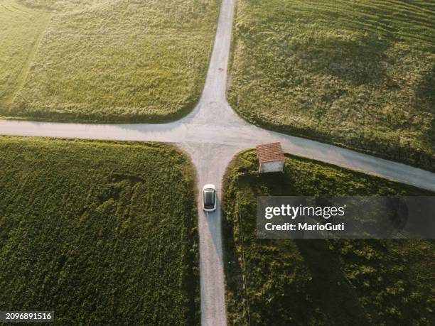 car in a road intersection - crossroad stock pictures, royalty-free photos & images