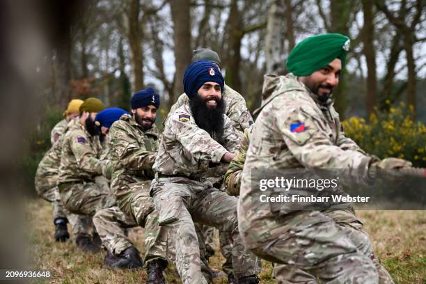 Soldiers take part in a tug of war competition during the Holla Mahalla Sikh military festival on March 19, 2024 in Aldershot, England. Holla...