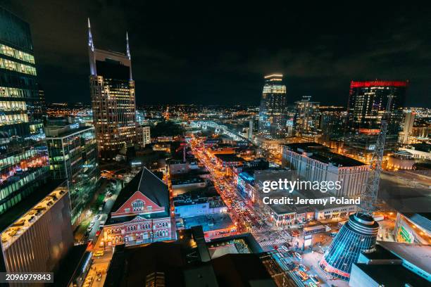 elevated view of broadway, downtown nashville at night, featuring "batman building" and ryman auditorium - nashville stock pictures, royalty-free photos & images