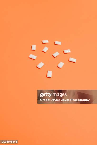 bubble gum on a red background - artificial sweetener stock pictures, royalty-free photos & images