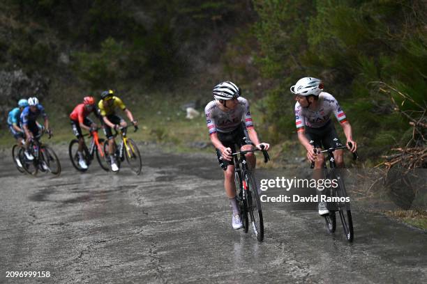 Stage winner Tadej Pogacar of Slovenia and Joao Almeida of Portugal and UAE Emirates Team attack in heavy rain during the 103rd Volta Ciclista a...