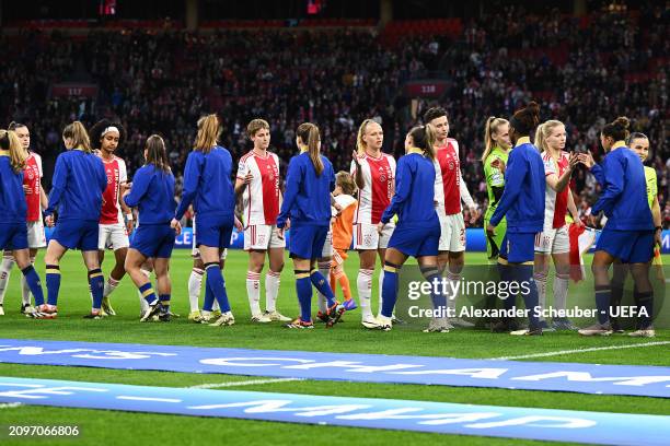 Players shake hands on pitch prior to the UEFA Women's Champions League 2023/24 Quarter Final Leg One match between AFC Ajax and Chelsea FC at Johan...