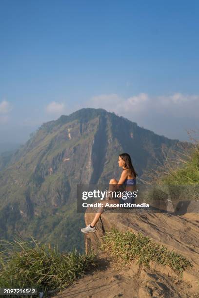 young woman on top of mountain - high resolution sports stock pictures, royalty-free photos & images
