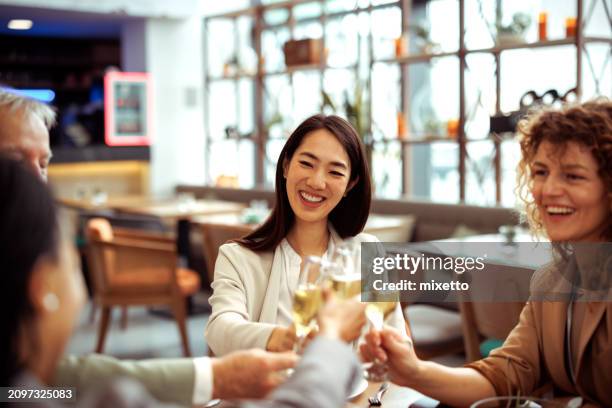 business colleagues celebrating success at the restaurant - honour board stock pictures, royalty-free photos & images