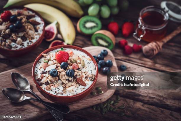 granola, yogurt and fruits bowl for healthy meal - oatmeal raisin stock pictures, royalty-free photos & images