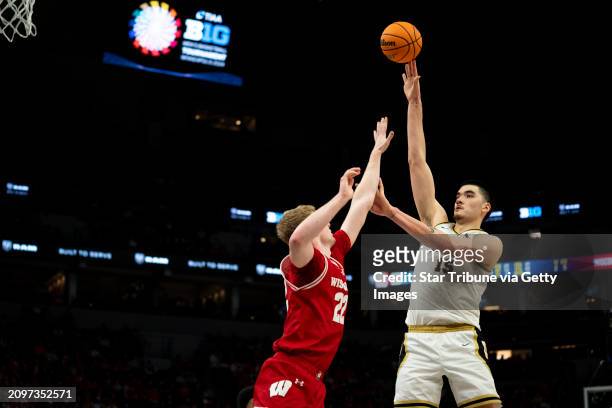 Purdue University Boilermakers center Zach Edey shoots over Steven Crowl of the University of Wisconsin during the second half of the first...