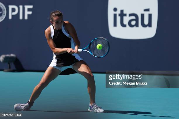 Clara Burel of France returns a shot to Caroline Wozniacki of Denmark during her women's singles match during the Miami Open at Hard Rock Stadium on...