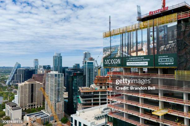 In an aerial view, apartments are seen undergoing construction downtown on March 19, 2024 in Austin, Texas. From peaking in 2022, home prices and...