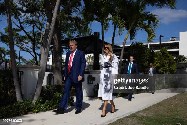 Former U.S. President Donald Trump and former first lady Melania Trump walk together as they prepare to vote at a polling station setup in the Morton...