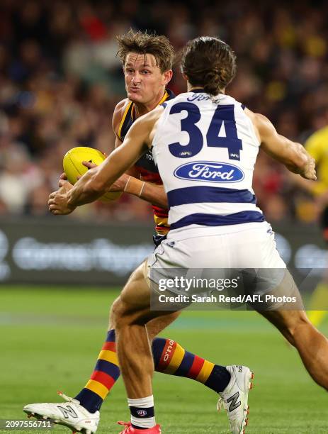 Matt Crouch of the Crows and Oisin Mullin of the Cats during the 2024 AFL Round 2 match between the Adelaide Crows and the Geelong Cats at Adelaide...