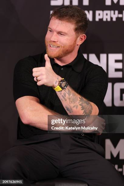 Canelo Alvarez gestures towards the audience during a news conference to preview his fight against Jaime Munguia at The Beverly Hills Hotel on March...