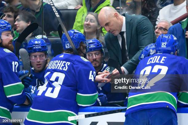 Vancouver Canucks head coach Rick Tocchet speaks with Quinn Hughes Brock Boeser Filip Hronek J.T. Miller and Ian Cole of the Vancouver Canucks during...