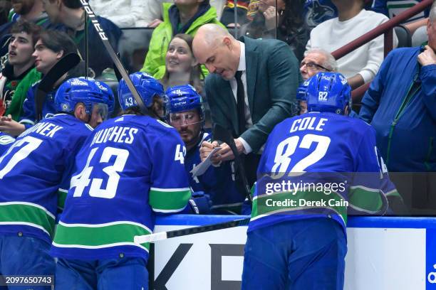 Vancouver Canucks head coach Rick Tocchet speaks with Quinn Hughes Filip Hronek J.T. Miller and Ian Cole of the Vancouver Canucks during the first...