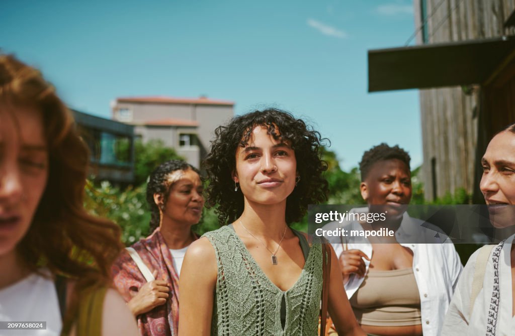 Young woman standing with friends after a yoga class at a wellness retreat