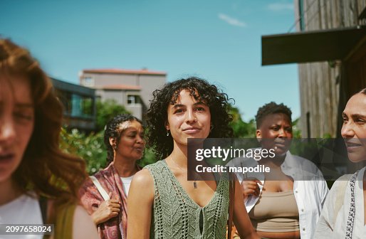 Young woman standing with friends after a yoga class at a wellness retreat Young woman standing with friends after a yoga class at a wellness retreat