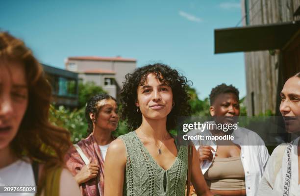 young woman standing with friends after a yoga class at a wellness retreat - group of people stock pictures, royalty-free photos & images