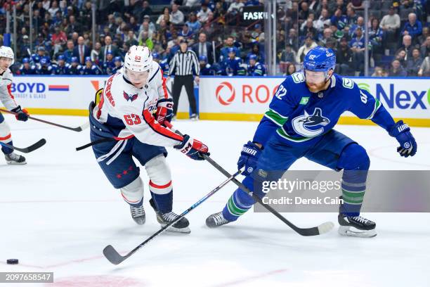 Ivan Miroshnichenko of the Washington Capitals is checked by Ian Cole of the Vancouver Canucks during the first period of their NHL game at Rogers...