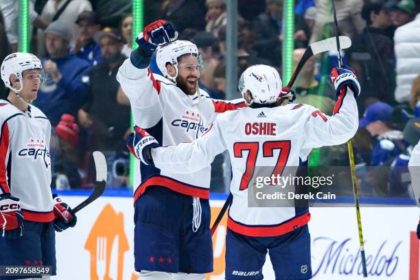 Tom Wilson and T.J. Oshie of the Washington Capitals celebrate after defeating the Vancouver Canucks during their NHL game at Rogers Arena on March...