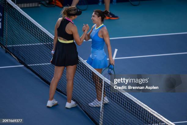 Simona Halep of Romania congratulates Paula Badosa of Spain on her win during her women's singles match during the Miami Open at Hard Rock Stadium on...