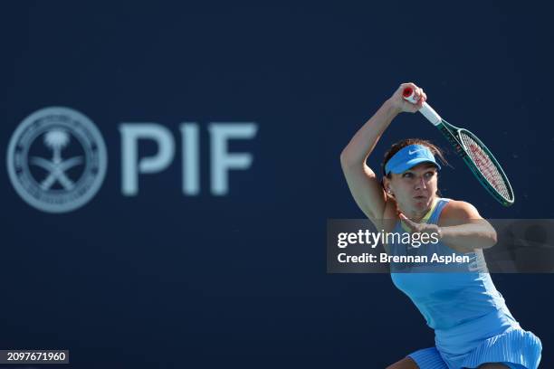 Simona Halep of Romania returns a shot to Paula Badosa of Spain during her women's singles match during the Miami Open at Hard Rock Stadium on March...
