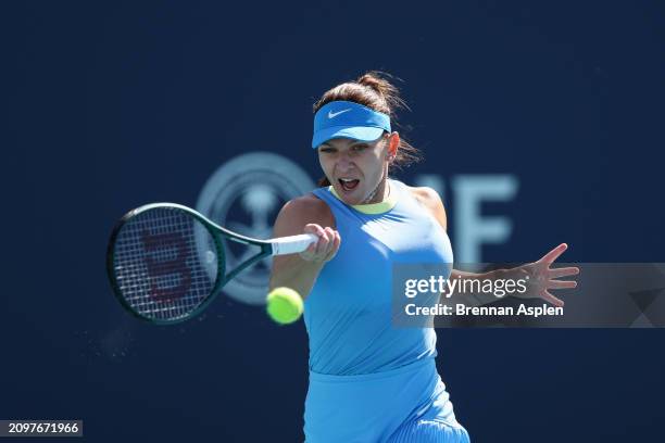 Simona Halep of Romania returns a shot to Paula Badosa of Spain during her women's singles match during the Miami Open at Hard Rock Stadium on March...