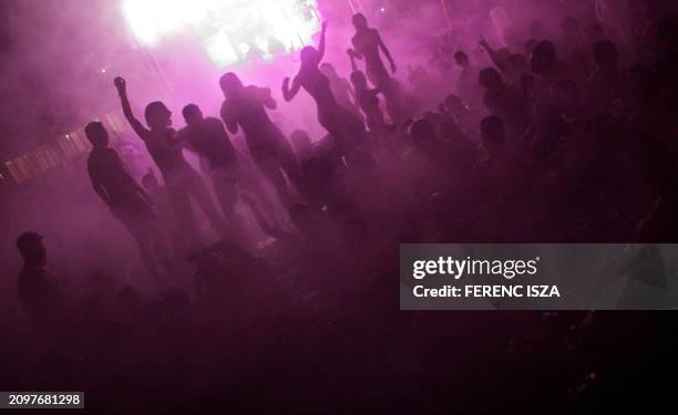 Hungarians and tourists dance in the open-air pool of the Szechenyi Thermal Bath during the 'Night of the baths' event organised by the Budapest...