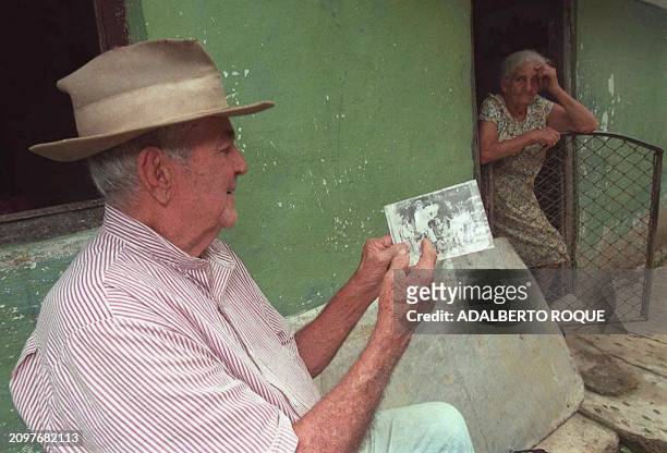 Felix Arencibia the oldest member of a water sect known as Los Los Acuaticos, "The Aquatics," shows a 1936 photo of the sect's founder Antonica...