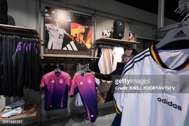 Germany's national team jerseys made by Adidas are pictured in official store on March 22, 2024 in Frankfurt am Main, western Germany ahead German...