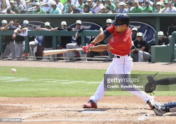 Masataka Yoshida of the Boston Red Sox hits a double in the first inning of a spring training game against the New York Yankees in Fort Myers,...