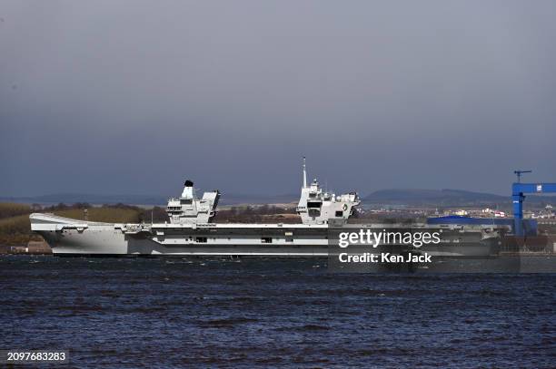 The Royal Navy aircraft carrier HMS Queen Elizabeth lies off Rosyth Dockyard, where she is to undergo repairs, on March 22, 2024 in South...