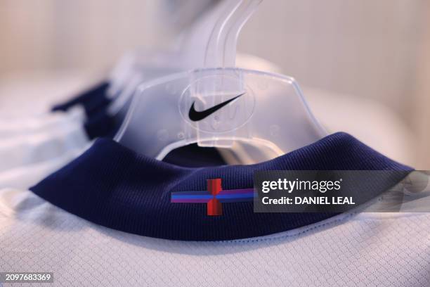 Racks of England's new Nike designed football shirt, with the controversial St George's cross, are displayed for sale in a central London store on...