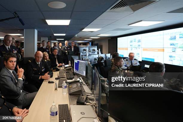 France's Prime Minister Gabriel Attal listens as General Arnaud Bouguignon in charge of anti-drone security for the 2024 Paris Olympic Games speaks,...