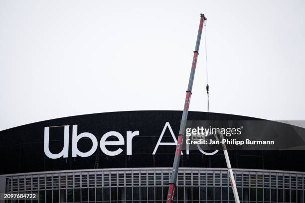 Crane lifts a letter into place during the renaming of the former Mercedes-Benz Arena to Uber Arena on March 22, 2024 in Berlin, Germany.