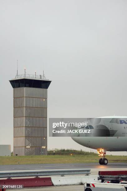 An Airbus A330 belonging to French company Air France taxis near the air traffic control tower on the Roissy airport runway, near Paris, 20 July...
