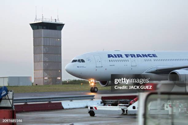 An Airbus A330 belonging to French company Air France taxis near the air traffic control tower on the Roissy airport runway, near Paris, 20 July...