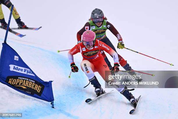 Switzerland's Saskja Lack and Canada's Brittany Phelan compete in heat 4 of the women's quarter-finals during the ski cross event of the FIS World...