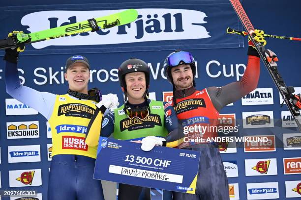Second placed Italy's Simone Deromedis, winner Sweden's David Mobaerg and third placed Canada's Reece Howden celebrate on the podium after the men's...