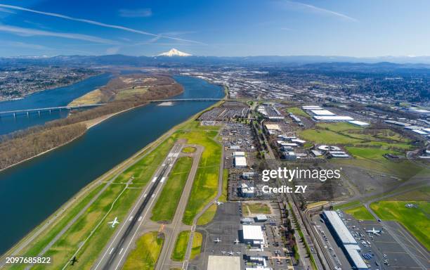 aerial view of portland international airport runway with columbia river and mount hood in background - gresham oregon stock pictures, royalty-free photos & images