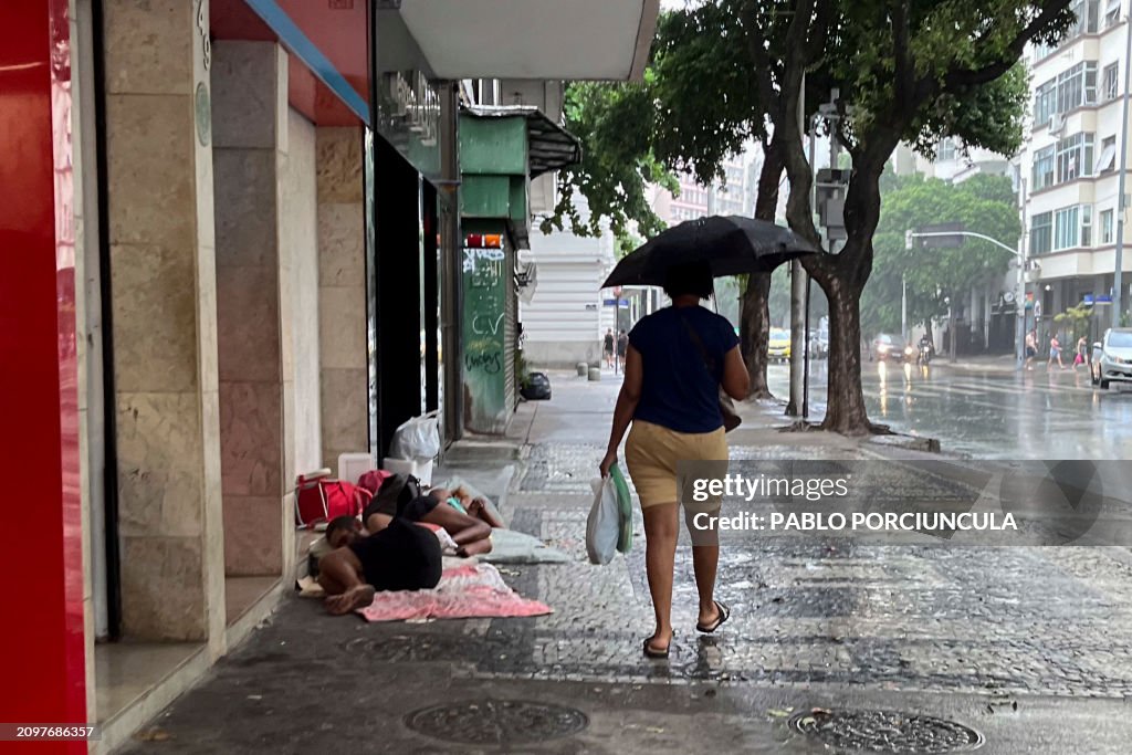 Homeless While Raining A woman shelters under an umbrella walking past homeless people... News ...