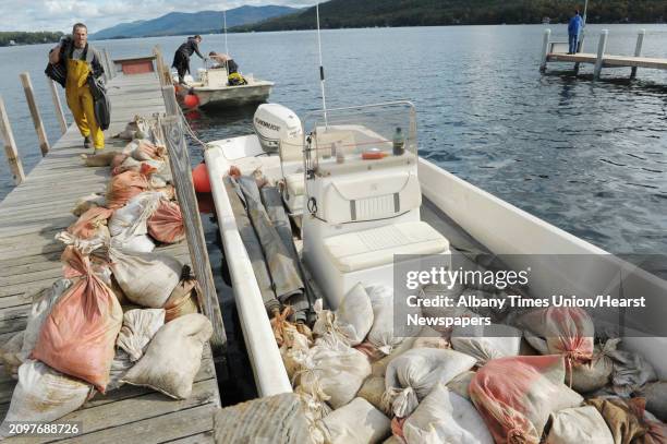 Divers with Aquatic Invasive Management load up mats, rebar and sandbags onto boats on Monday, Oct. 8, 2012 in Lake George, NY. Crews with the...